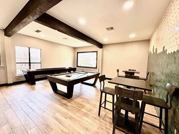 A room with a pool table and a dining table. at Ventana Oaks Apartments, Austin, 78717